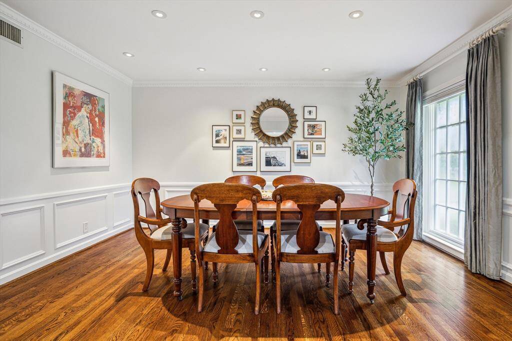 Large windows flood the formal dining room with natural light and views of the front lawn. This gracious space connects seamlessly to the formal living room. Elegance and warmth combine for unforgettable gatherings.