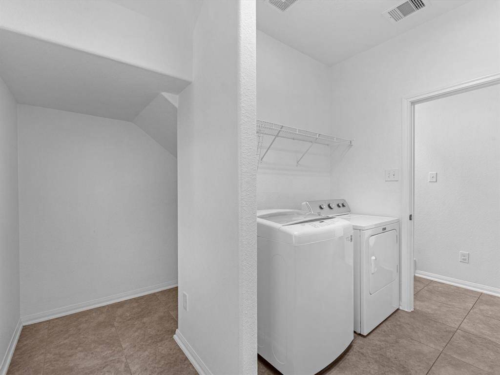 The extended laundry room has extra storage space. Shown here is the storage area under the stairs.