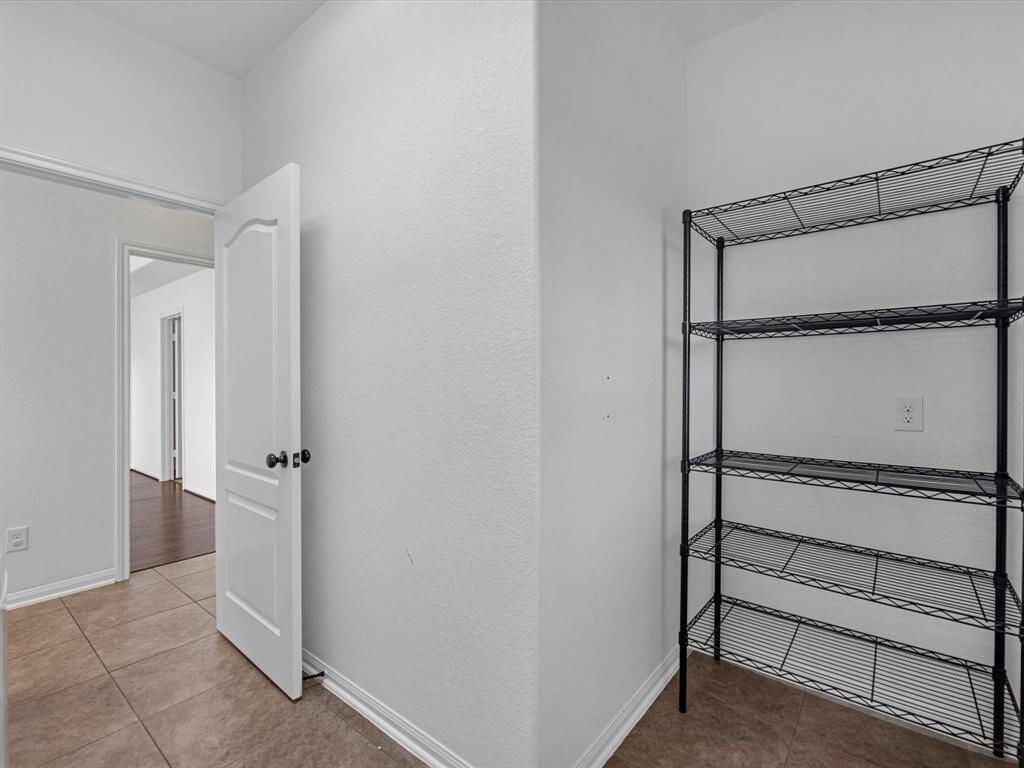 And additional shelved area in the laundry room. Note this is NOT the pantry; there is a walk-in pantry adjacent to the kitchen, but this can be your Costco overflow pantry!