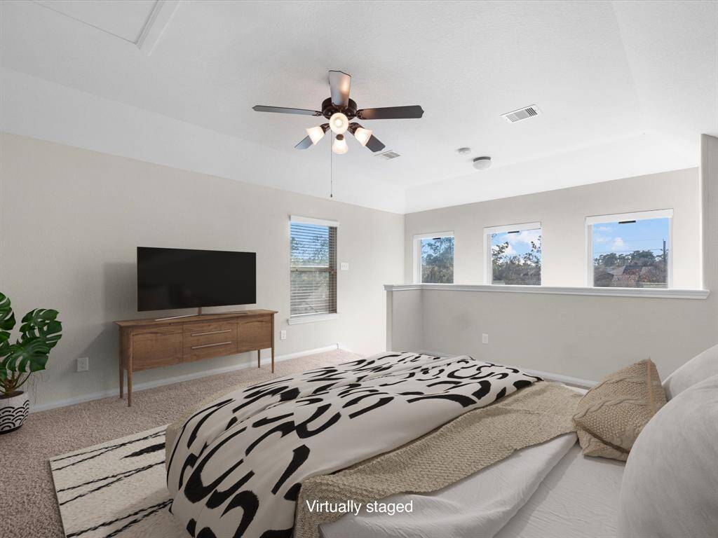 The 4th bedroom has 3 windows with motorized shades overlooking the backyard.