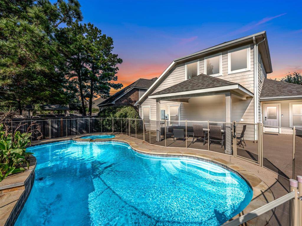 Now on to the show-stopping pool and backyard! The pool comes with a safety gate installed, and has a waterfall feature.