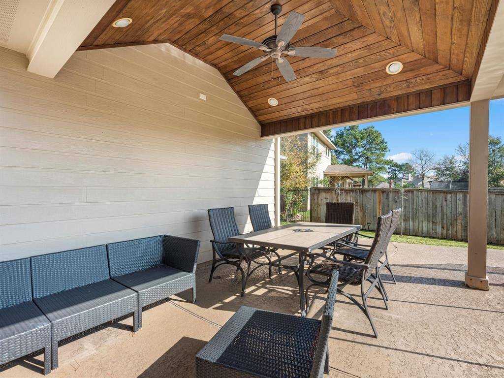 A covered patio is adjacent to the pool, providing a comfortable space in the heat of summer.