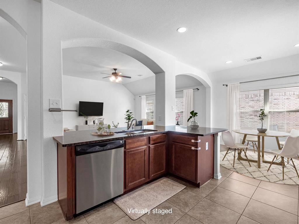 The heart of the home: the kitchen. This kitchen island has breakfast bar seating on the other side, and a large breakfast room area is adjacent.
