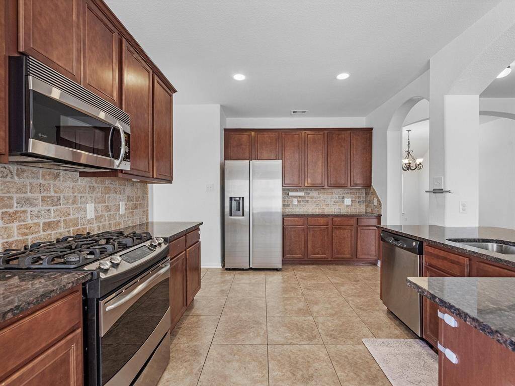 There is plenty of room to work in this kitchen! Enjoy a plethora of cabinets for all your kitchen wares.