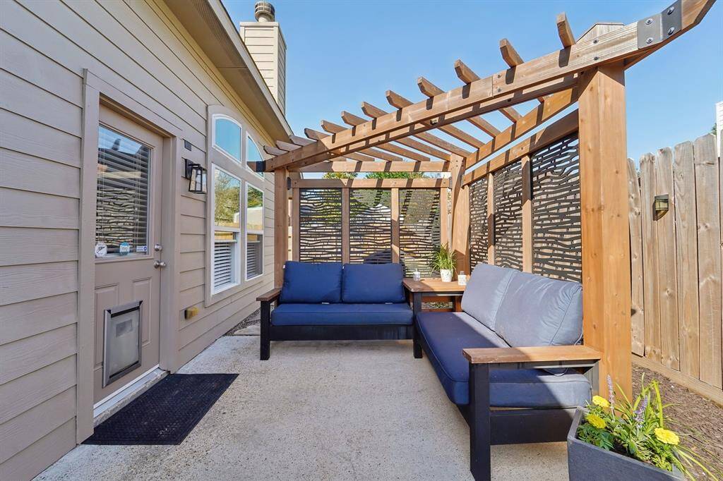 Cozy backyard sitting area with a pergola for those hot summer days!