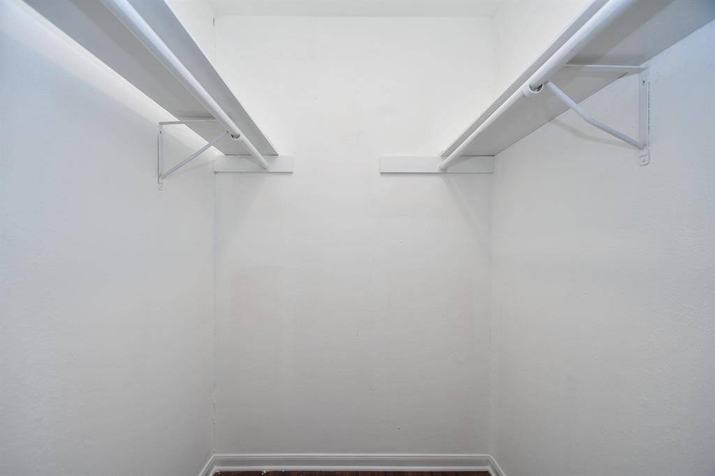 Closet #2 is a well-lit walk-in closet with dual hanging rods, perfect for ample clothing storage.