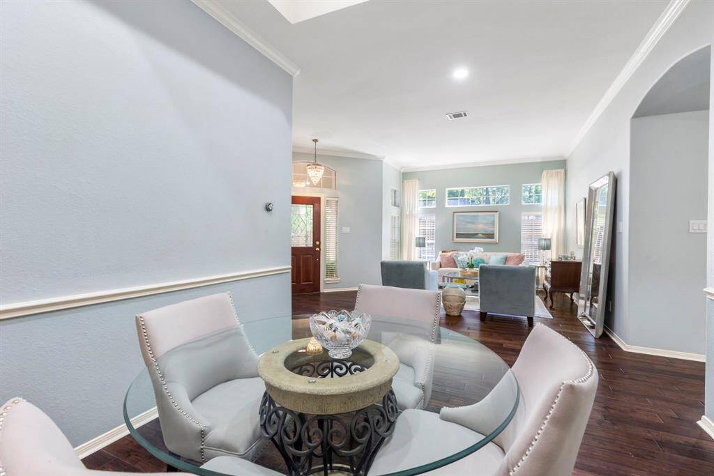 The formal dining room and living room are filled with natural light. Notice the crown molding all around.