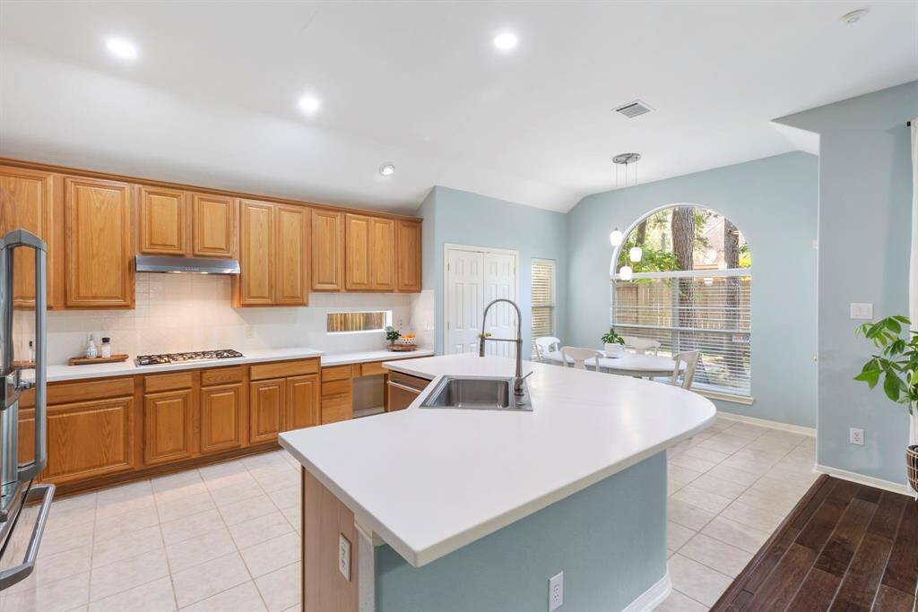 The spacious kitchen has additional seating space around the kitchen island.