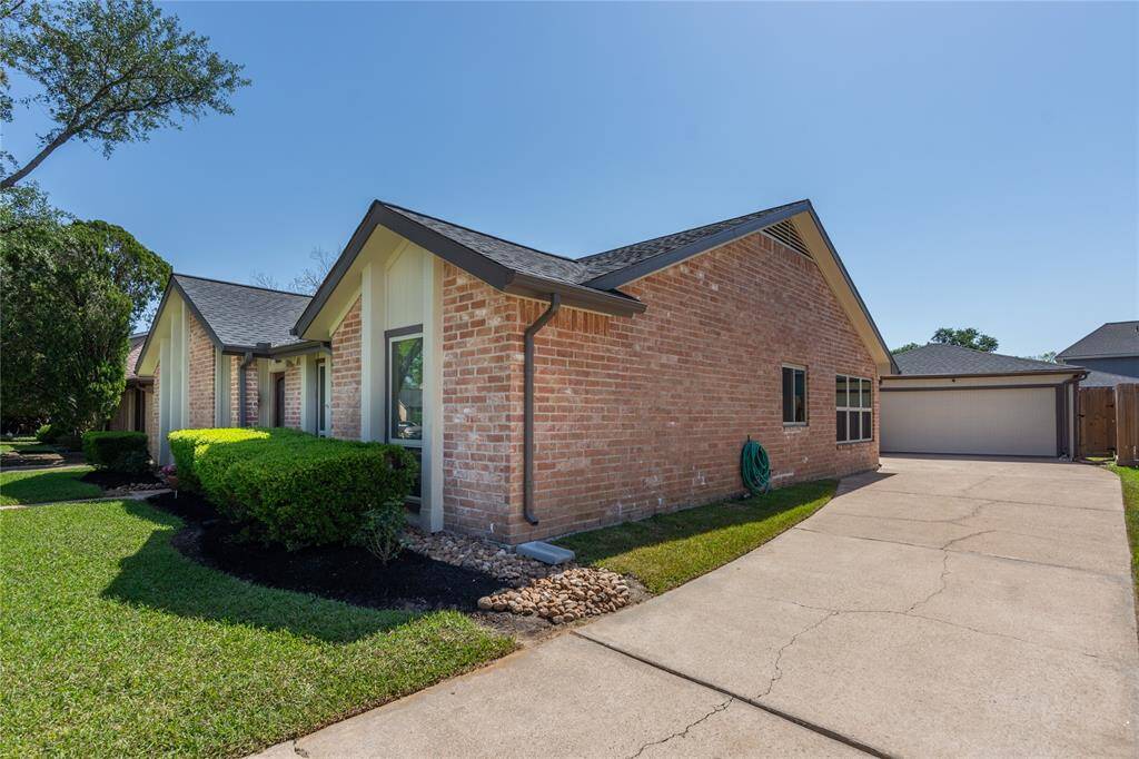 LONG DRIVEWAY FOR EXTRA PARKING & DETACHED 2 CAR GARAGE.