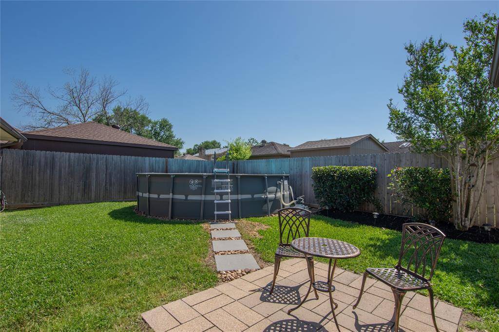SPACIOUS YARD W/ WALKWAY TO POOL.