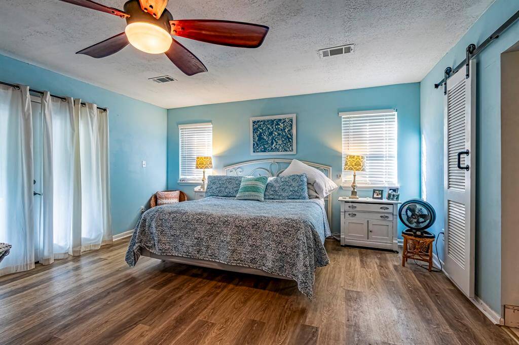 Primary bedroom with a sitting area and adjoining balcony