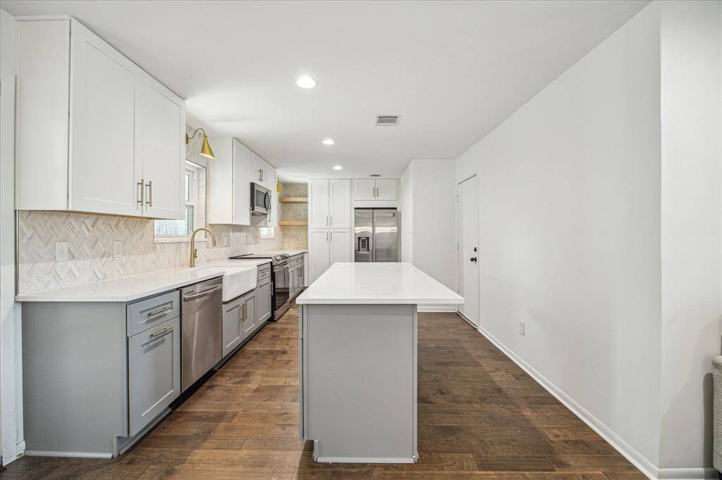 Large functional kitchen. Refrigerator conveys with sale of the home. Island large enough for counter stools and another eating space.