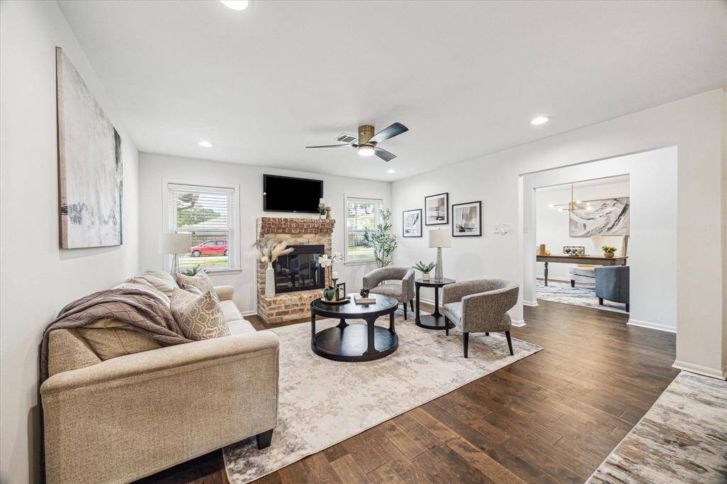 Open concept living with wood burning fireplace. This room has multiple ways it can be laid out for use.