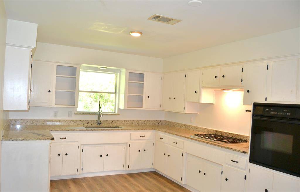 Functional kitchen with a view out to the front of your property!