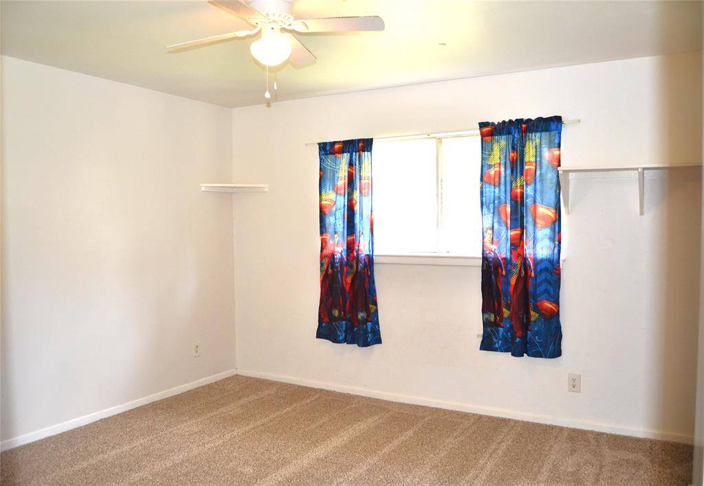 Secondary bedroom with windows facing the backyard.