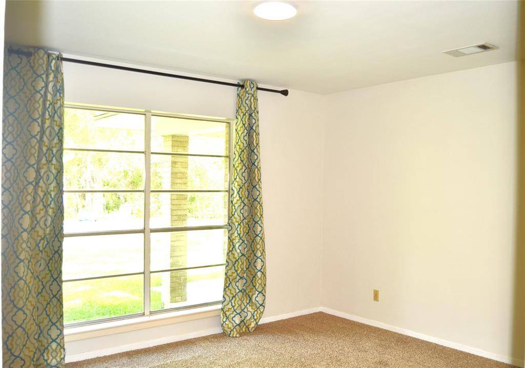 Secondary bedroom with windows facing the front yard.