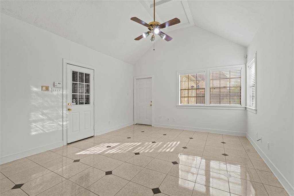 This bright and versatile space is filled with natural light, making it perfect for a variety of uses. The high vaulted ceiling adds an airy and open feel, while the elegant tile flooring enhances the room's polished look. Large windows allow sunlight to pour in, creating a warm and inviting atmosphere.Whether you envision this space as a sunroom, home office, workout area, or cozy den, its flexible layout and private entrance make it a standout feature of the home.
