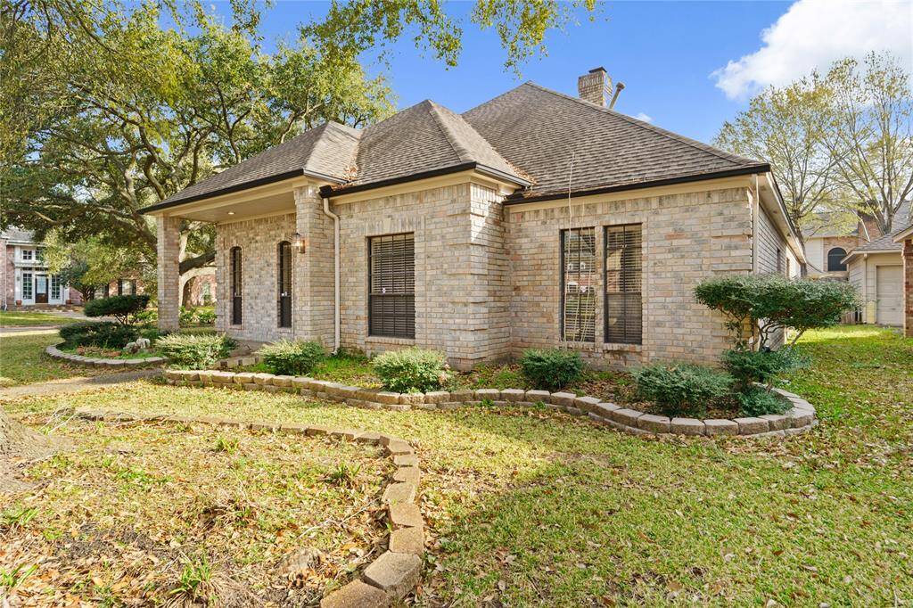 This beautifully maintained home boasts timeless curb appeal with its classic brick exterior and charming architectural details. Nestled among mature trees and lush landscaping, this home offers a welcoming and peaceful setting. The covered front porch provides the perfect spot to enjoy the neighborhood's serene atmosphere, while the large windows allow natural light to flood the interior. Thoughtfully designed garden beds add a touch of greenery, enhancing the home's warm and inviting character.