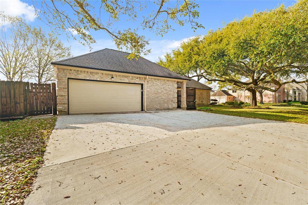 This spacious two-car garage and extended driveway provide both convenience and functionality, making parking a breeze. The charming brick exterior seamlessly blends with the rest of the home, while the wide driveway offers ample space for guests or additional vehicles.Surrounded by mature trees and a well-maintained yard, this area feels both private and inviting.Whether you're looking for extra storage, a workshop space, or simply a secure place for your vehicles, this garage is designed for you.