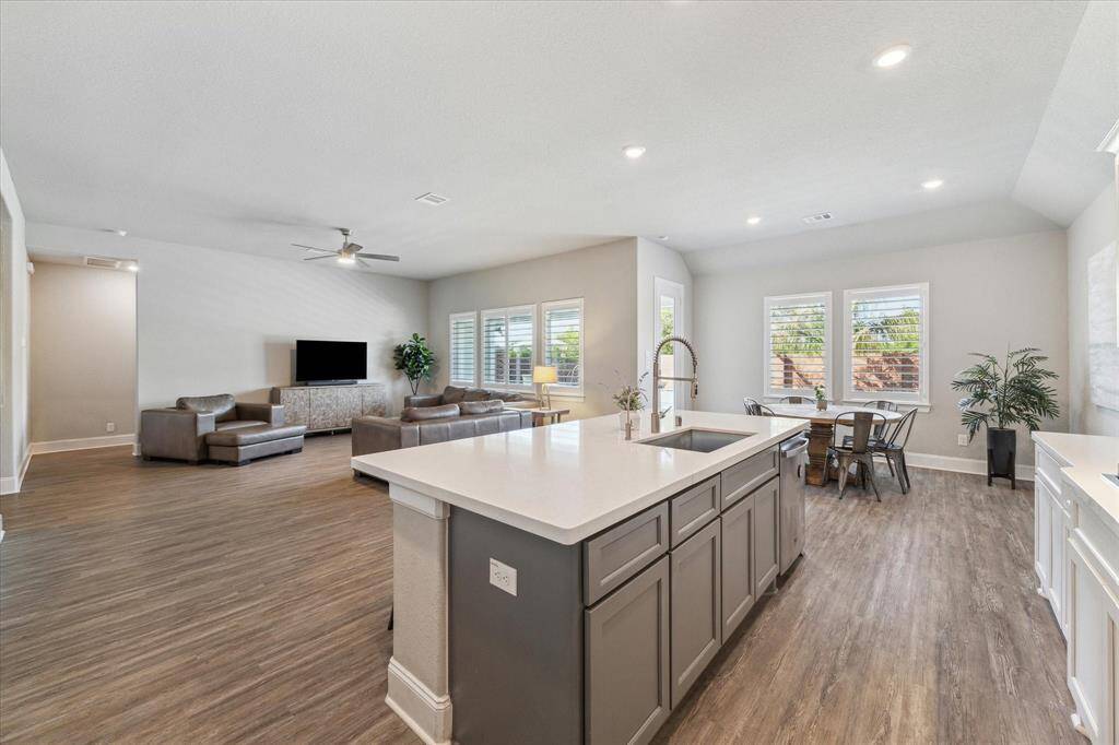 The quartz coutertops, upgraded cabinetry are elegant in this home. While you are cooking in the kitchen you will still be able to enjoy time with your loved ones.