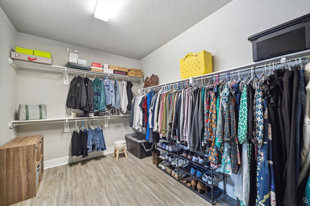 The primary closet is spacious and is located off the primary bath.