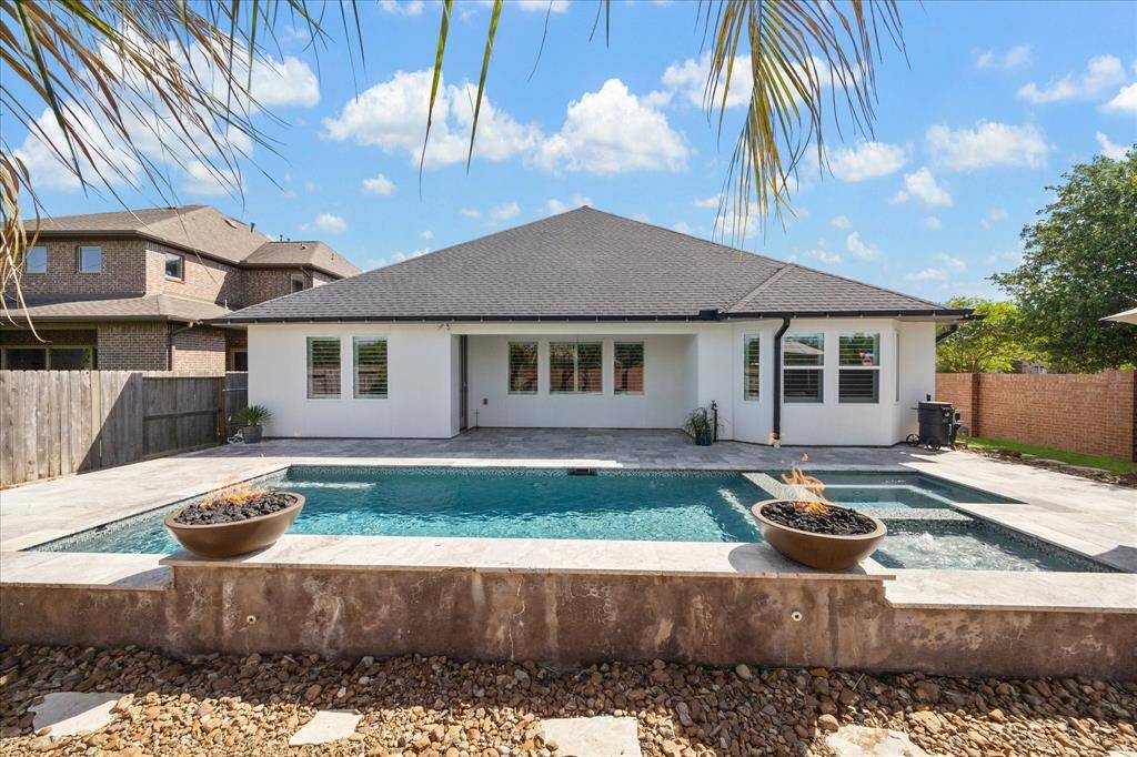 This crystal clear pool with hot tub and fire features will be perfect for your summertime enjoyment.  This backyard oasis does not have a back neighbor.