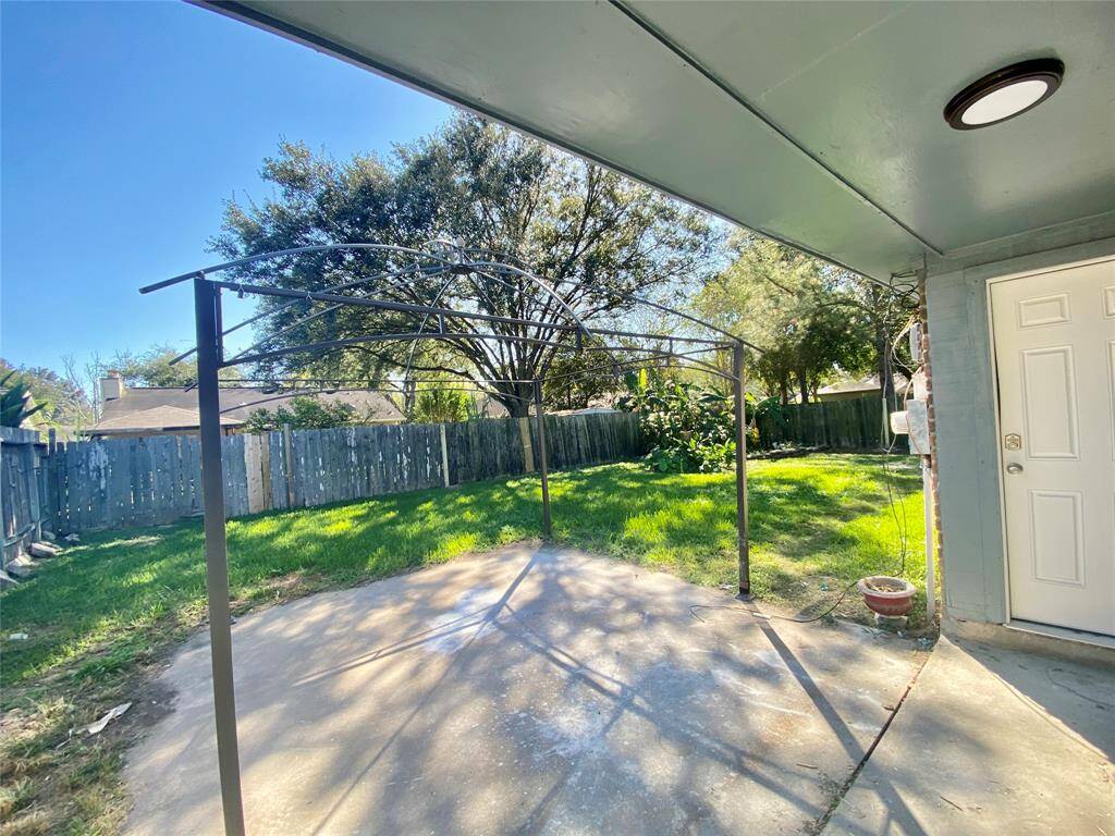 Covered back patio and great size backyard- Old pic: The metal structure has been removed