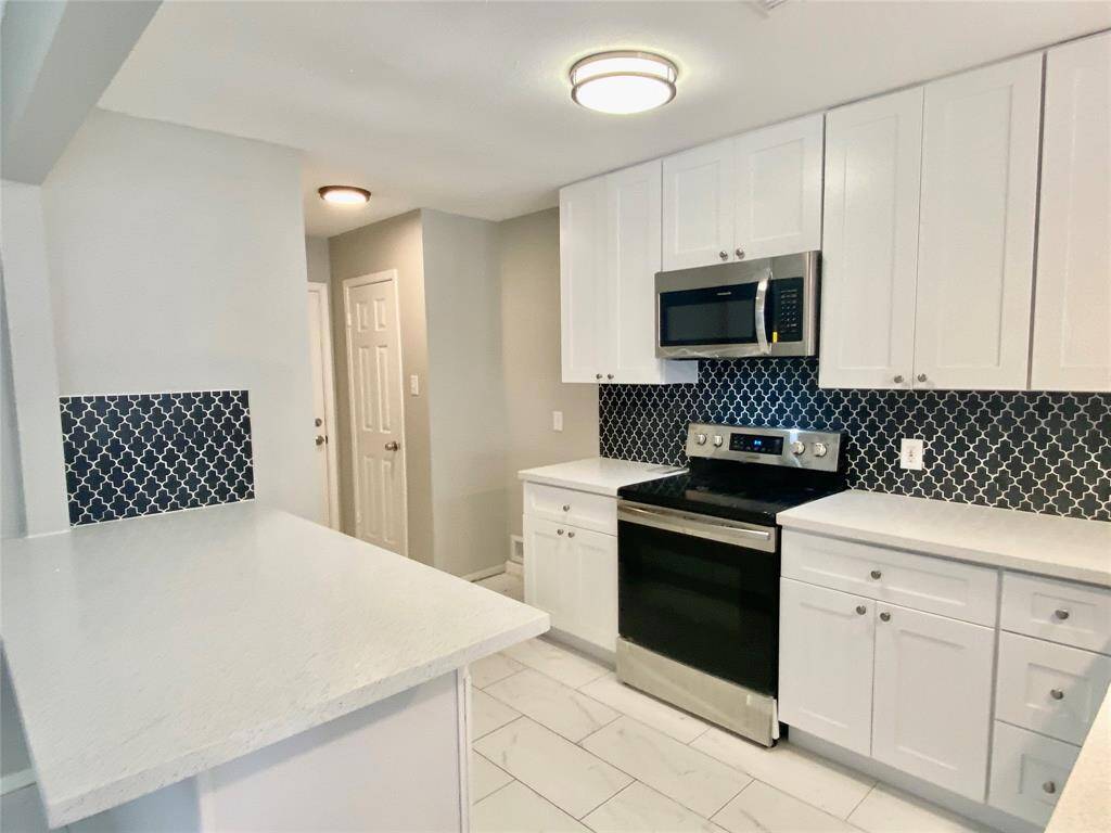 Kitchen with new cabinets, appliances and quartz countertops