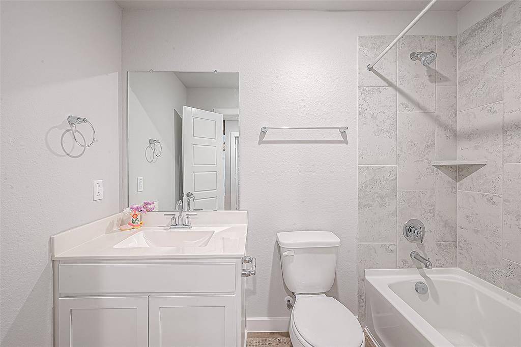 View of guest bathroom with tub/shower combo.