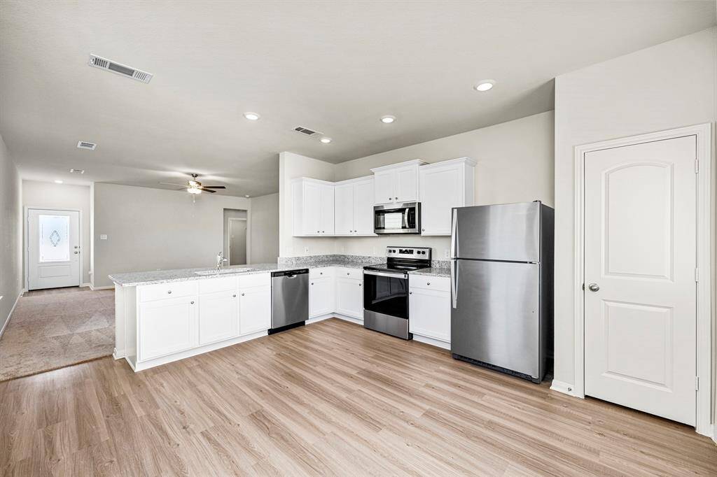 The kitchen comes chef-ready with Whirlpool kitchen appliances and granite countertops.
