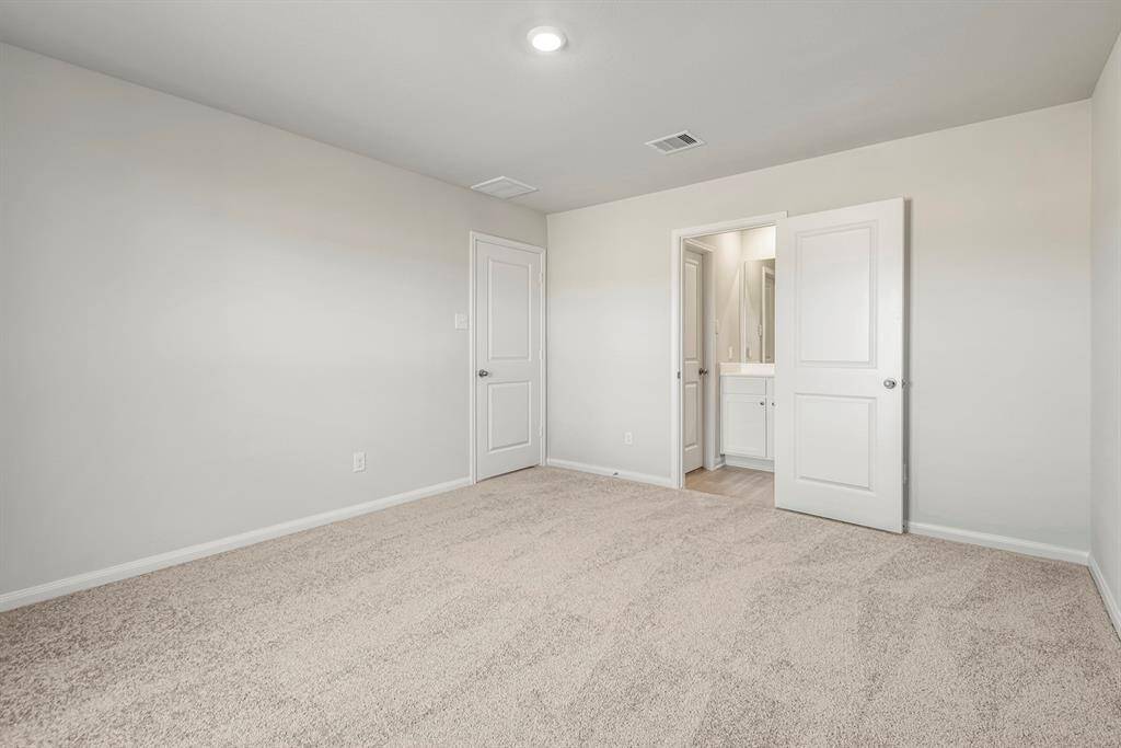The master bedroom is spacious and leads into a private master bathroom.
