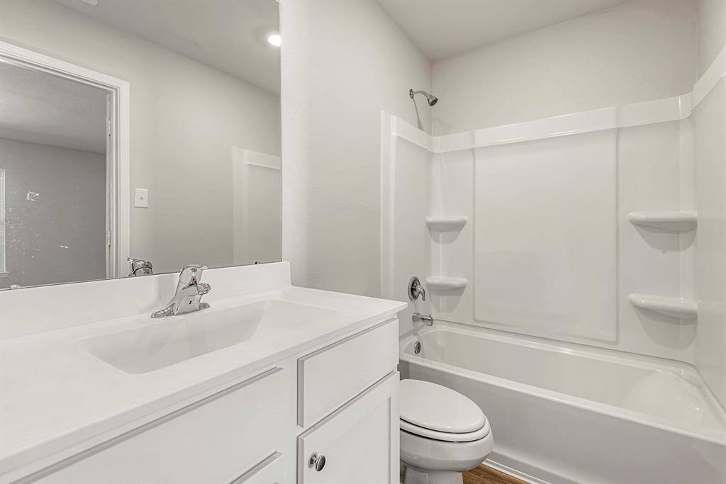 The master bathroom is fully equipped with a shower and bath combination.