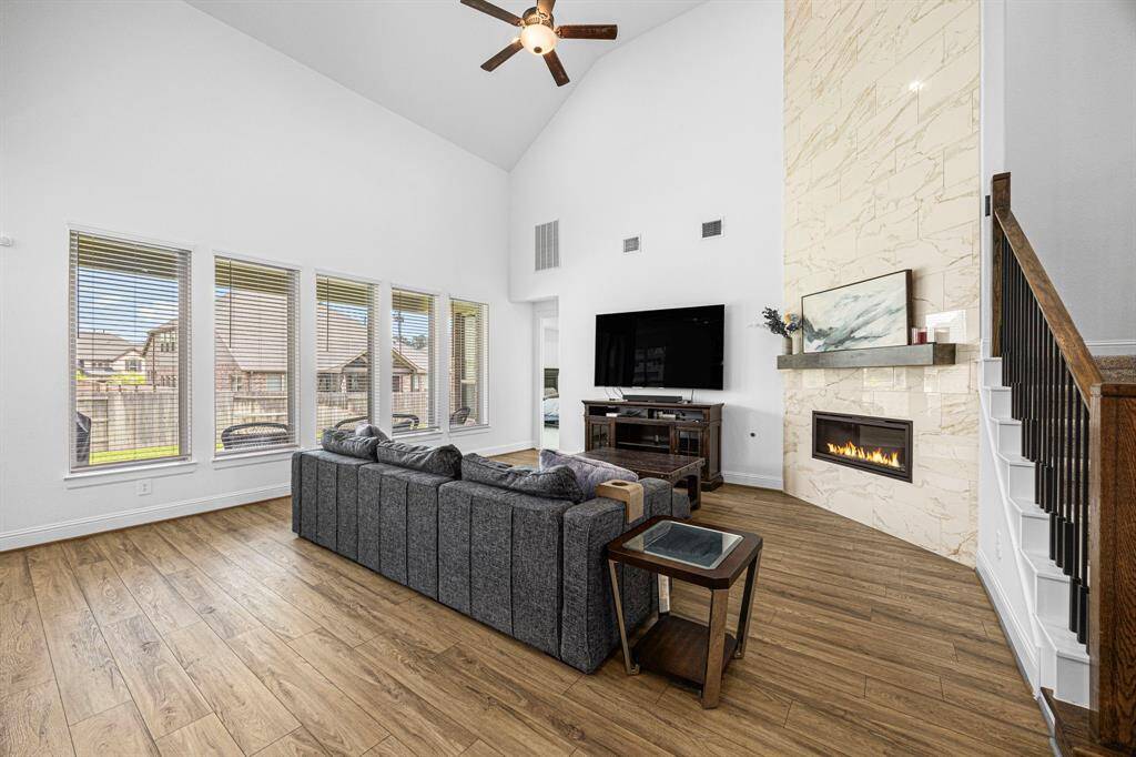 Next you enter the large living room with high ceilings and floor to ceiling fireplace.