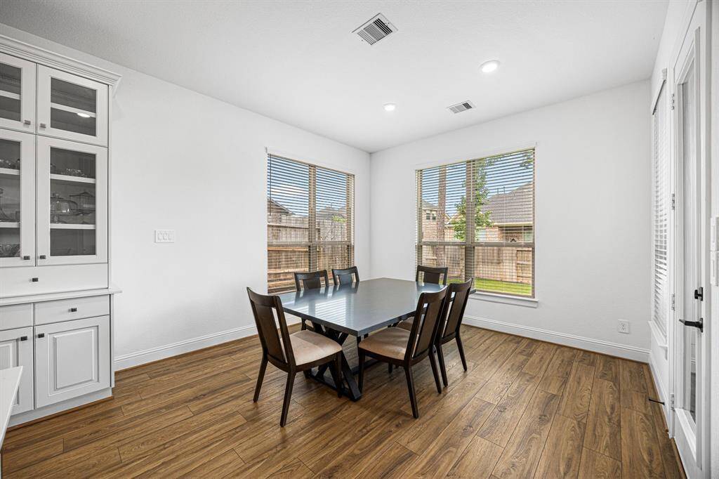 As you enter the kitchen space you will find the breakfast nook surrounded by windows, as well as a exterior door to the outside patio.