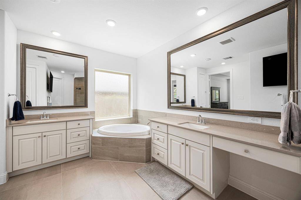 Double vanity as well as a make up table. Great counter space, cabinet space, and lighting!