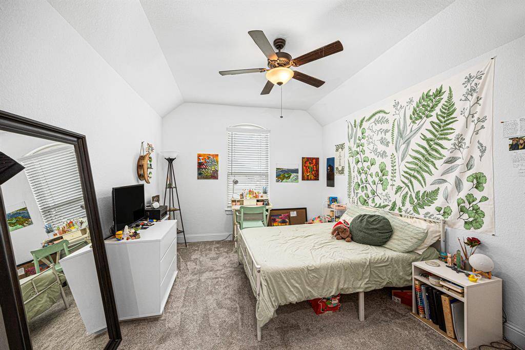 Secondary bedroom with tall ceilings and natural light.