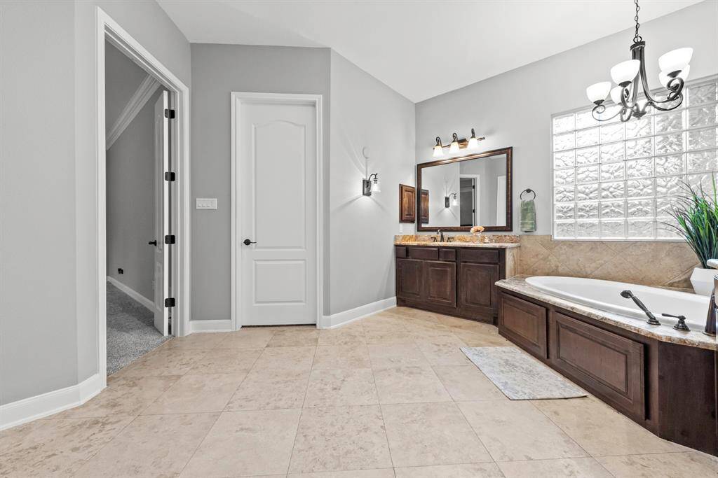 Large walk in closet inside bathroom.