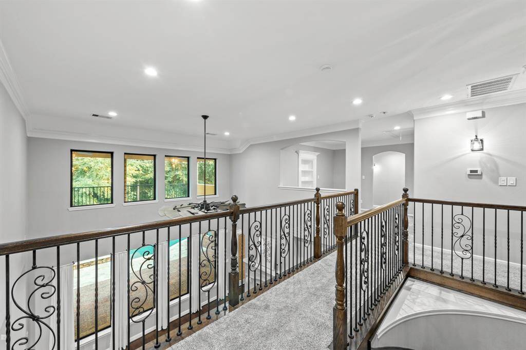 Balcony overlooking entry and living room. Recently installed carpet upstairs.