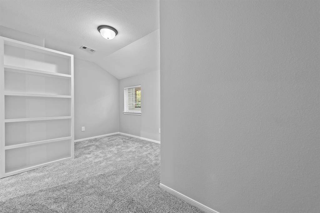 Secret storage room with window behind bookshelves.  Elevator entry in room.