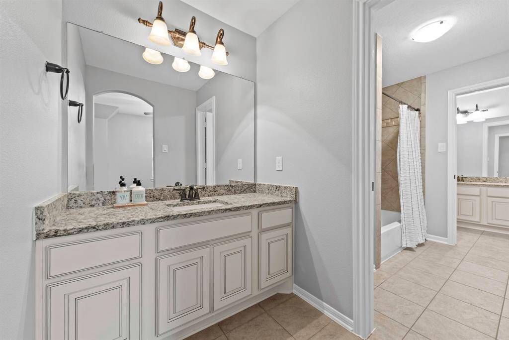 Jack & Jill bath, separate vanities for each room.