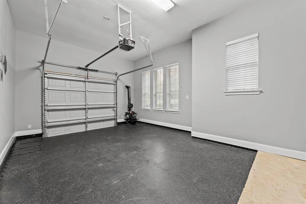 Single bay garage, one of four, with fitness mat perfect for an in home gym. Whole house water softener located in alternate garage.