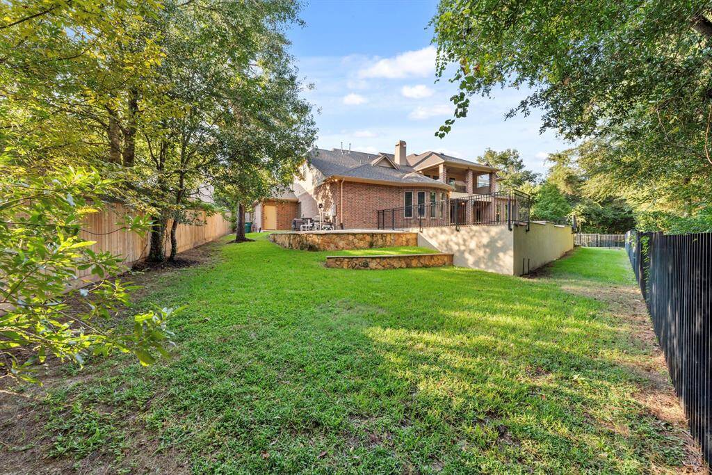 Side yards of pool area with privacy fencing at property line.