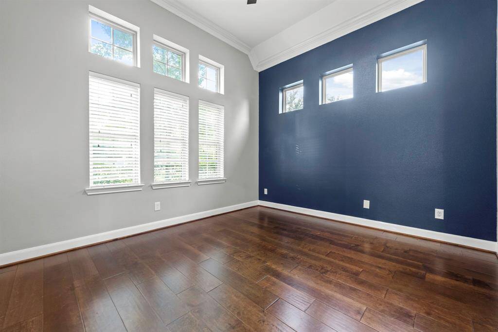 Private front facing office offers ample windows, high ceilings and crown molding.