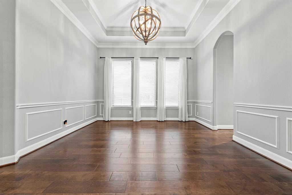 Formal dining with custom lighting and decked ceilings.