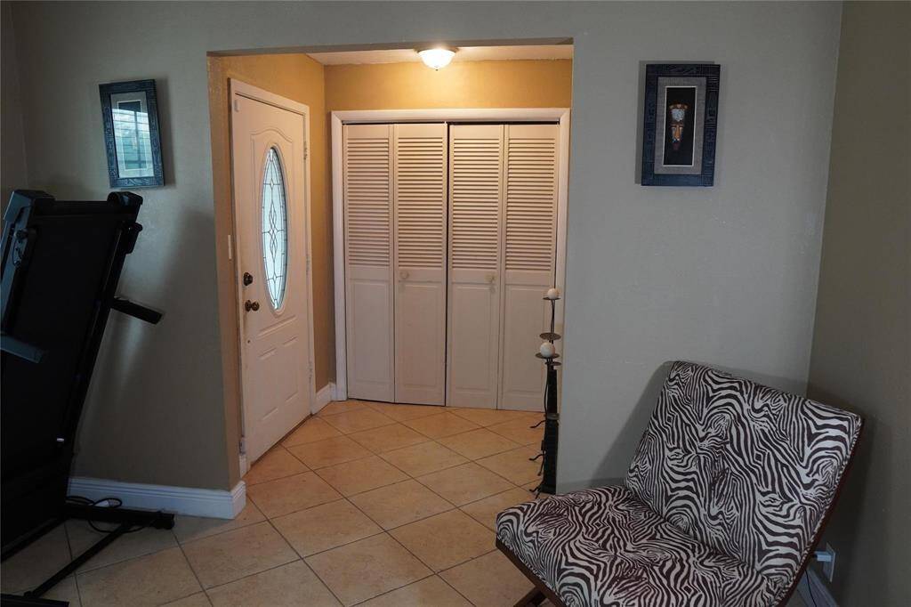 Upon entering, you are greeted by a warm and open living space accentuated by tile flooring.