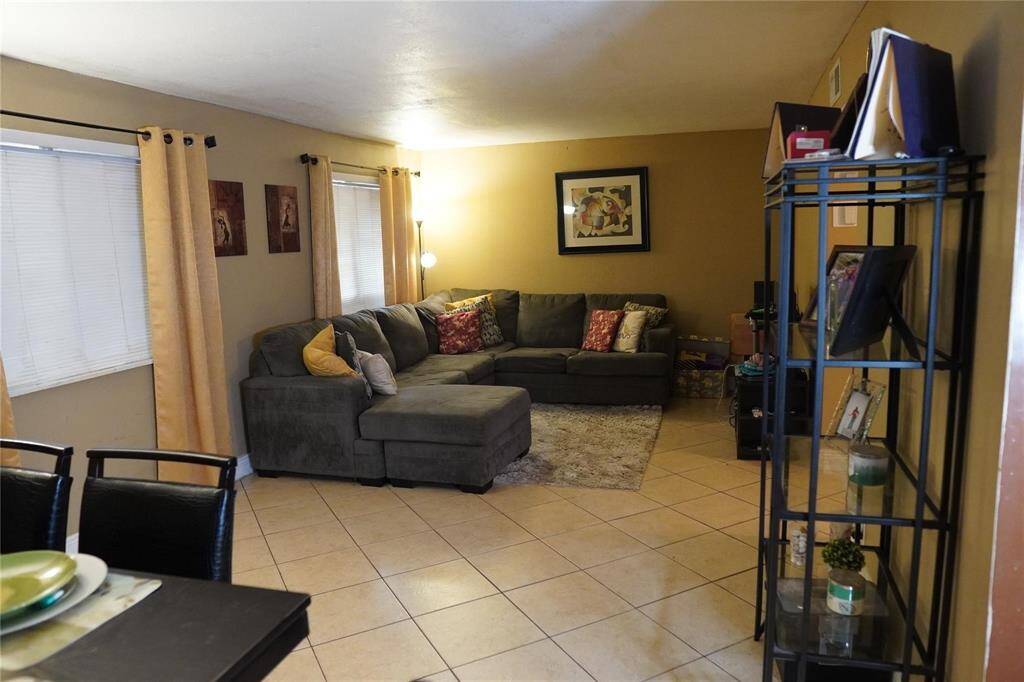 The den seamlessly flows into a dining room, creating an ideal space for both everyday living and entertaining guests.