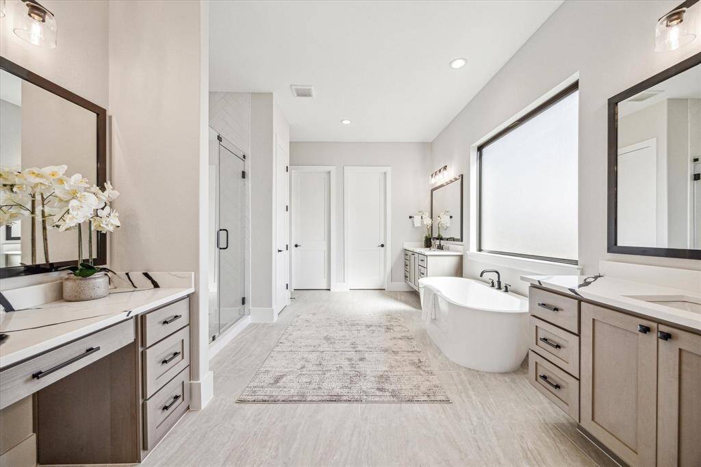 Primary Bath has 3 vanities - 2 with sink and floating cabinetry, 1 has space for seating