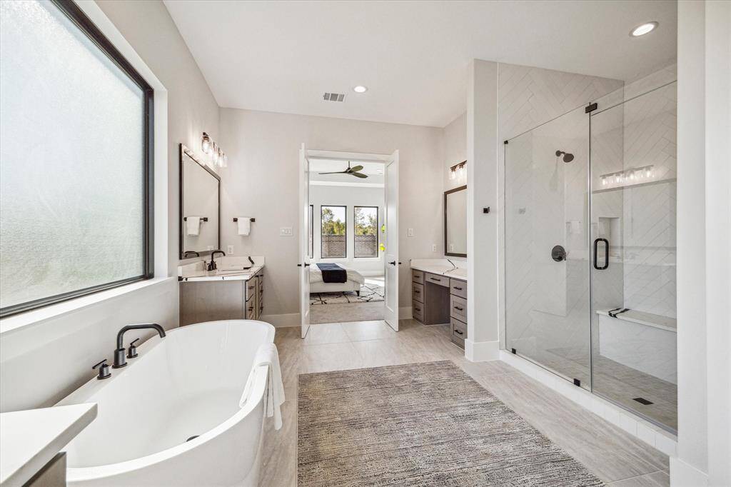 Primary Bath has 67” soaking bathtub and an oversized walk-in shower with dual heads