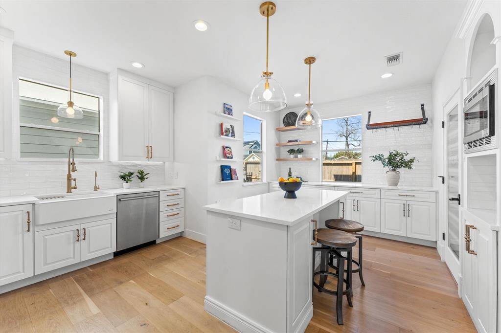 A chef’s dream. Quartz countertops, custom cabinetry, and designer lighting make this kitchen as functional as it is beautiful.