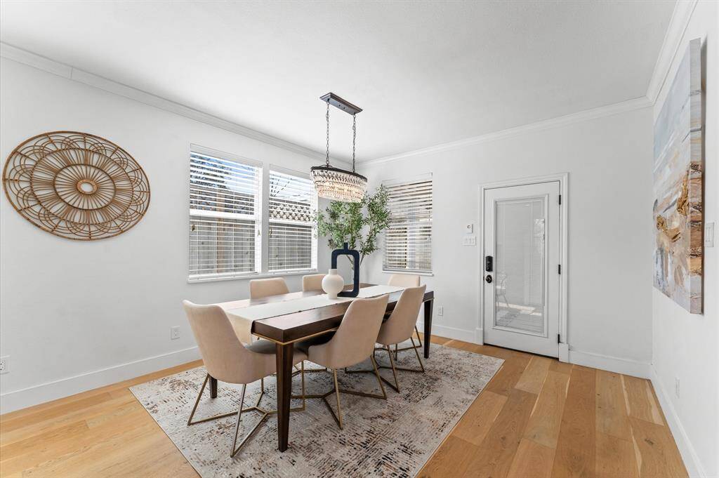 Dine in style under a glistening crystal chandelier, with direct access to the backyard deck and outdoor kitchen for seamless indoor-outdoor entertaining.